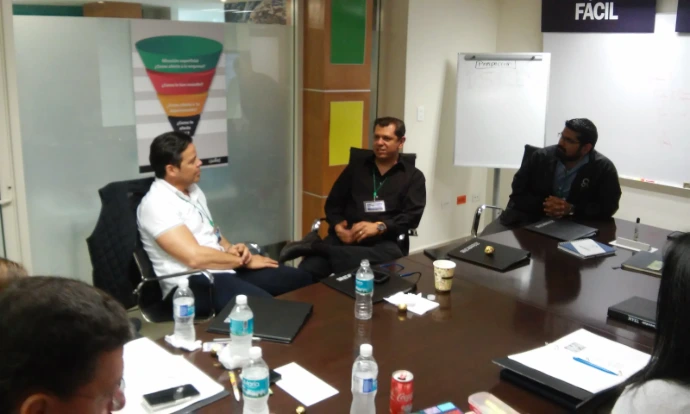 Fotografía de un equipo de hombres en su oficina conversando sobre los webinars de Econvalor